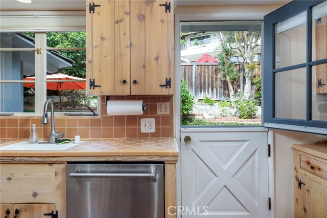 The Dutch door opens to the peaceful and lush backyard.