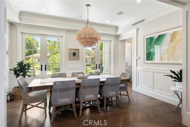 Stunning dining room with access to large front patio and herringbone wood floor detail