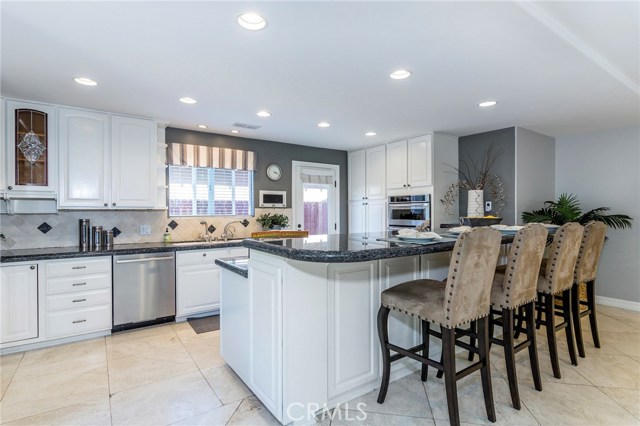 Updated, open-concept kitchen with stainless steel appliances and granite counters.