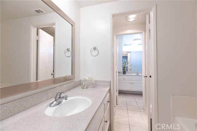 From the bath tub area, walk through a privacy door to the toilet and walk in shower, then through another door to the secondary sink off of the master bedroom.