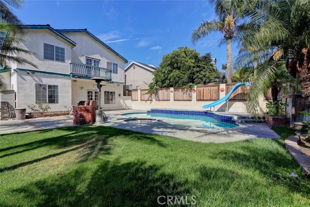 Backyard Area with Lawn Adjacent to Pool and Patio