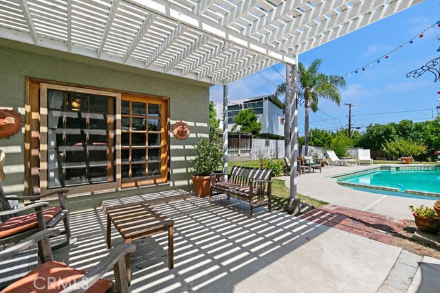 family room opens to patio, pool, and huge grassy backyard