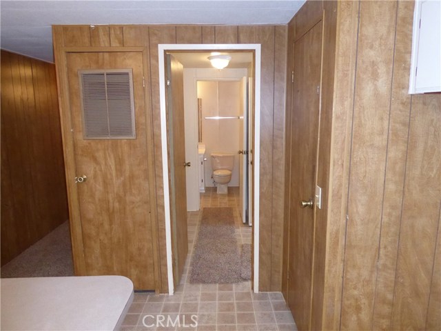 From the kitchen looking thru the laundry room to the main bathroom. Laundry room has a door to the back covered deck that can be used as a mud room.