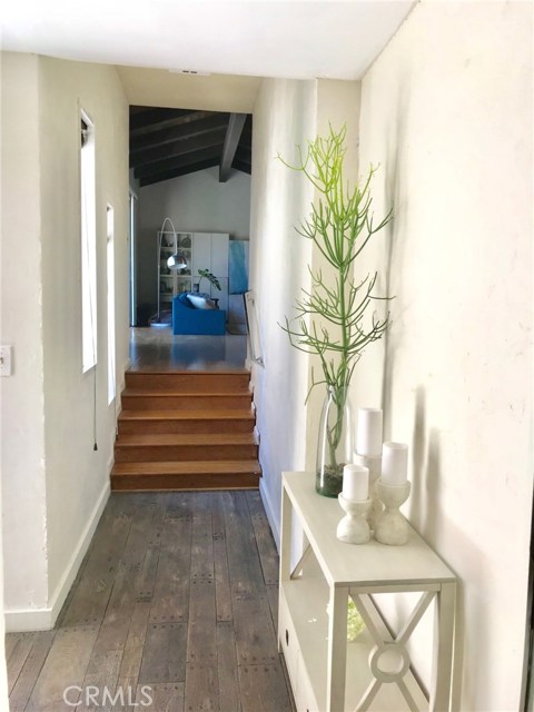 Entryway/hallway leading to living room. Wall newly remodeled. Entryway/hallway leading to living room. Wall newly remodeled.