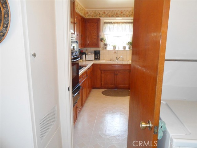 View into Kitchen from The Utility Room. Door can make it Quieter when closed upon Washing and Drying Clothes.