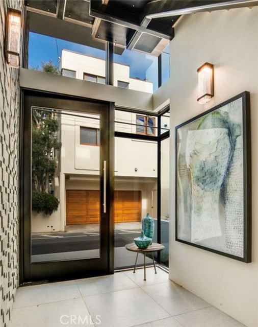 The bright and open entry way has chic styling and gorgeous architectural details