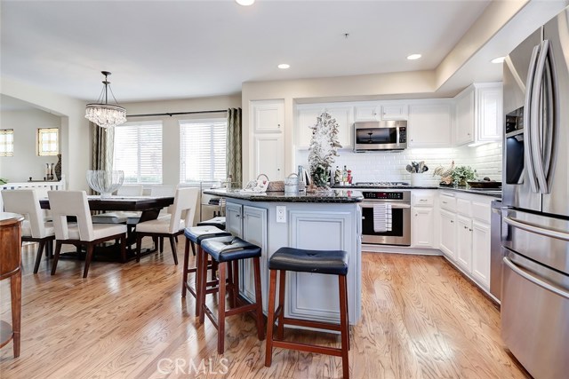 Hardwood floors and modern accents are throughout the formal dining room and kitchen.