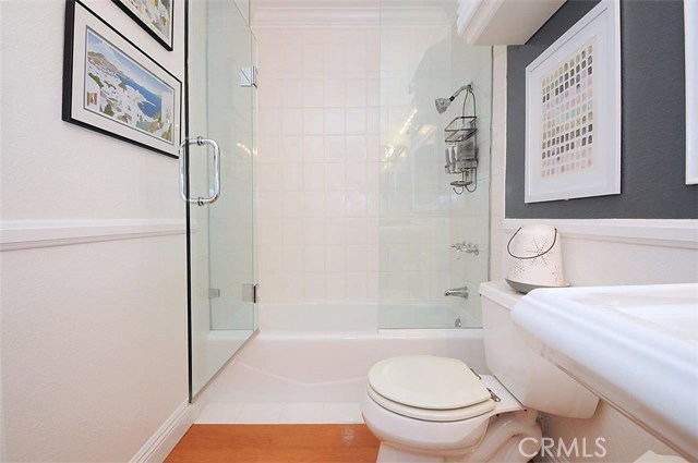 Tub and Shower with White Tile and Custom Shower Door