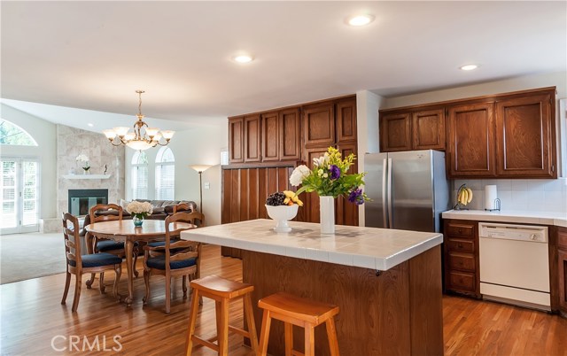 Kitchen has center island, oak floors and large dining area. Open floorplan lets family room and backyard to be visible from kitchen