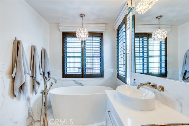 The classic white marble and quartz counter tops give the master bath a sleek and spa-like appeal. Enjoy the gorgeous soaking tub after a long day.