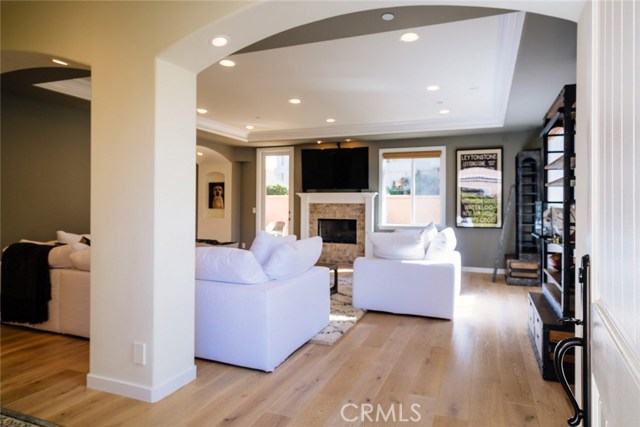 The open living room with fireplace opens connects to the back yard.