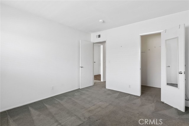 Bedroom looking towards closet and door to hall