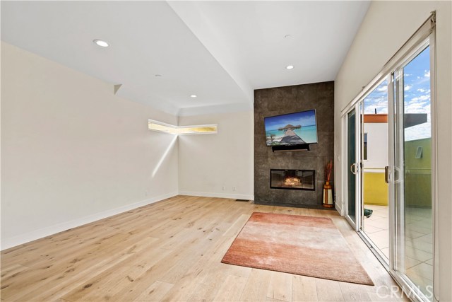 Gas fireplace oriented as a focal point along with the balcony