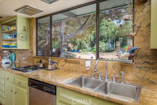 Kitchen with granite counters looking out to yard