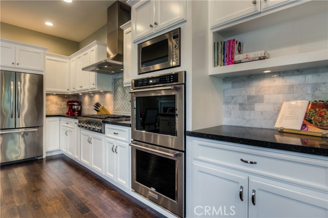 Gorgeous custom kitchen with Thermador 6-burner stove top and double ovens.