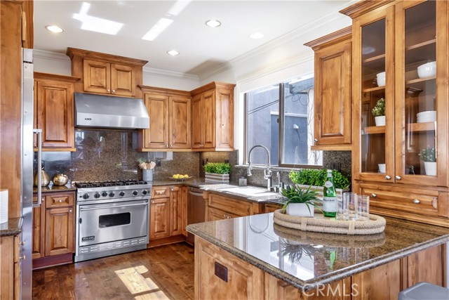 Entertainers kitchen opens to the living room and features, granite counter tops, beautiful cabinetry and Viking professional appliances