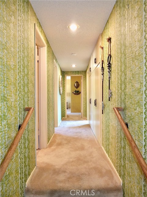 The hallway leading to three spacious bedrooms and two baths