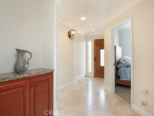 Travertine flooring welcome you into a stunning foyer