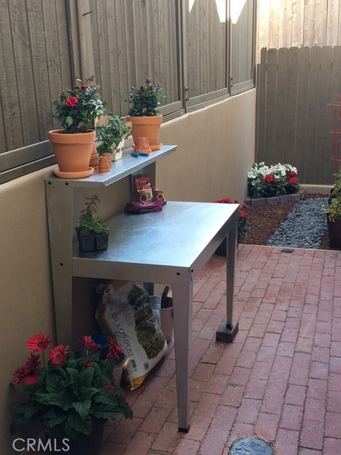 Brick patio leading to stone walkway...