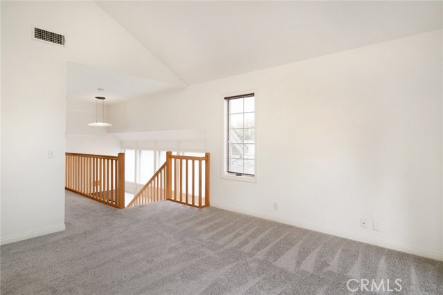 Upstairs family room and staircase. Entire east facing wall of opaque glass illuminates living room on entry level and staircase.