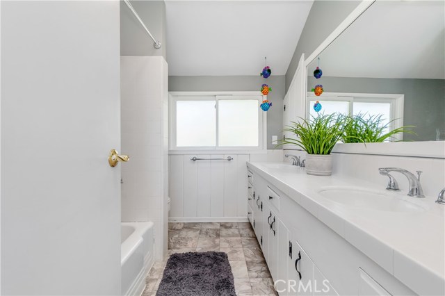 Bathroom #2 serves the upper level bedroom and features dual sinks and shower in tub.