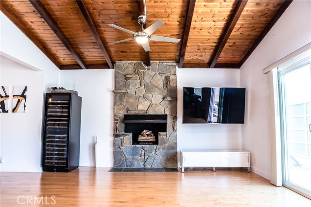 A little of the original home left for memory sake... gas/wood-burning fireplace... vaulted beamed wood ceilings in family room!