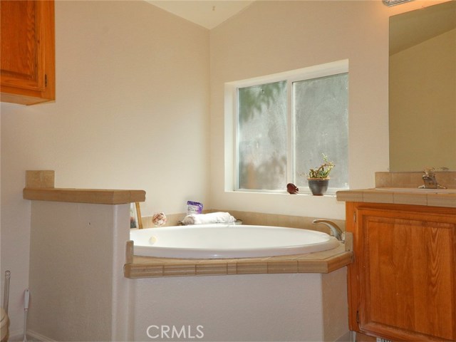 Master bath has large tub and....