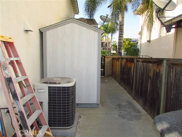 EAST SIDE OF HOUSE WITH STORAGE SHED