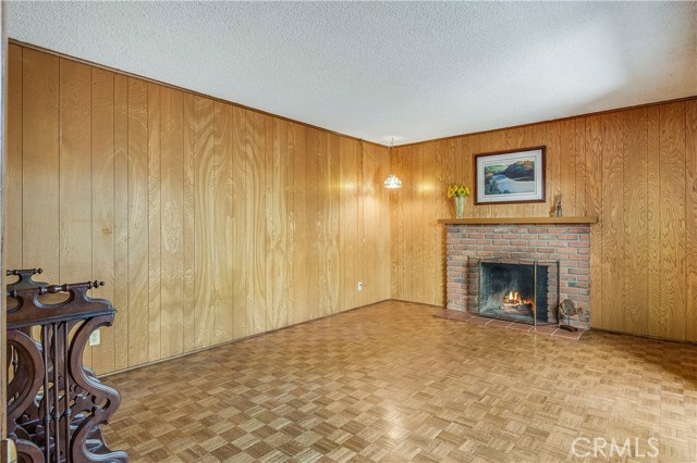 Family room with hardwood floors, wood buring fireplace and a closet could be a 4th bedroom if needed.