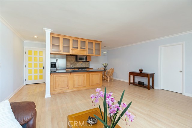 Open concept with connected kitchen, dining ell, and living room. Door to the right is a large room that can be used for an additional office or storage room. The room measures approx. 8'X10'