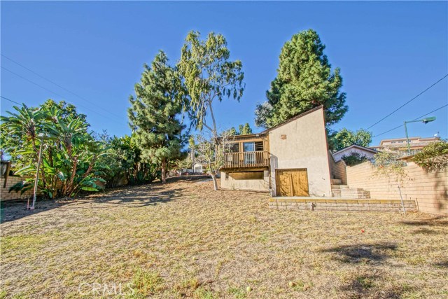 Another view/angle of the yard and back of the garage/storage structure