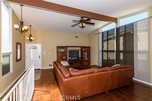 Spacious living room with high ceiling and new double pane windows.