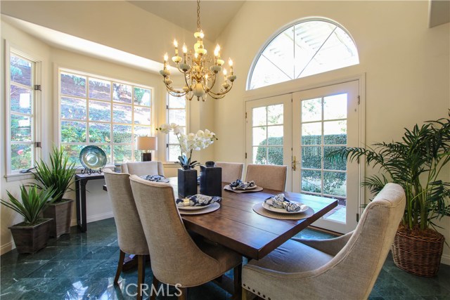 Dining room opening through French Doors to lovely patio.