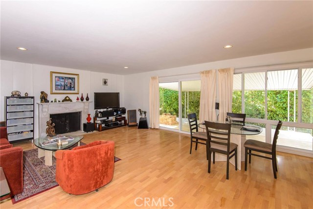 Spacious great room with beautiful white marble fireplace mantle.