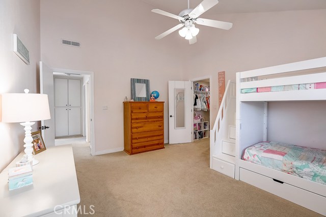 2nd bedroom with walk in closet and cathedral ceilings