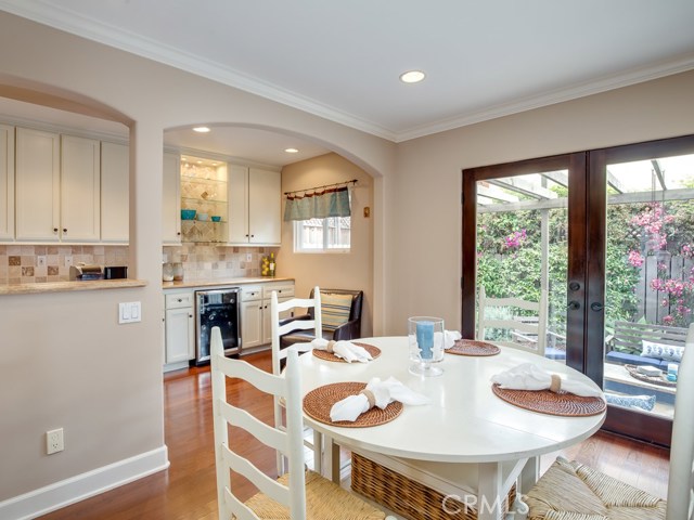 Clear glass French doors help to bring the outside in giving an expansive sense to the dining space.