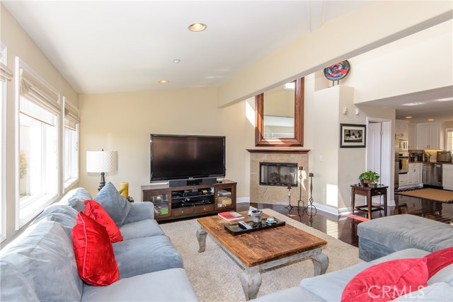 Living room with gas fireplace and looking into the kitchen!