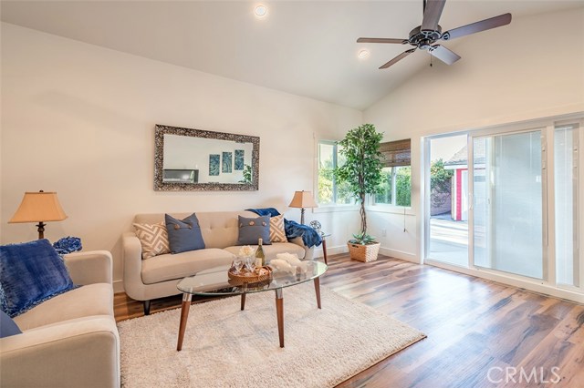 Living room with sliding glass doors leading to back patio and/or the garage and cottage.