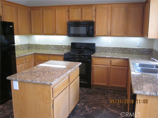 Granite counter-tops, stainless steel sink. Note plenty of electrical for appliances.