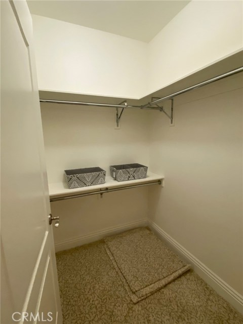 Master Bedroom - Large Walk-In Closet with Built-In Shelving & Clothes Racks.