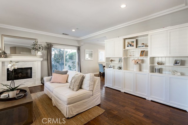 Recessed lighting and Hickory hardwood floors opening up to the backyard