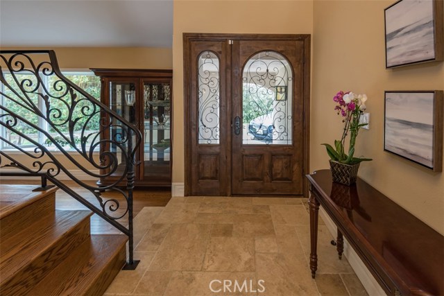 Grand entrance with cathedral ceilings, travertine flooring