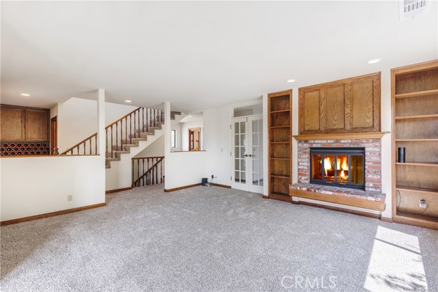Living room, stairwell to top floor, additional storage and shelves