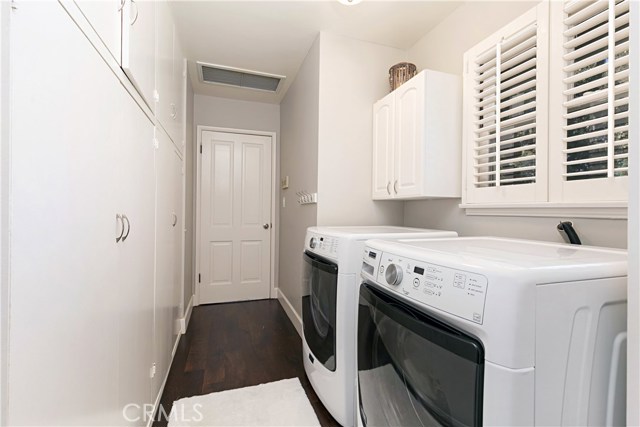 Laundry room with storage, kitchen side view.