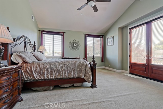Master bedroom with double doors opening to balcony