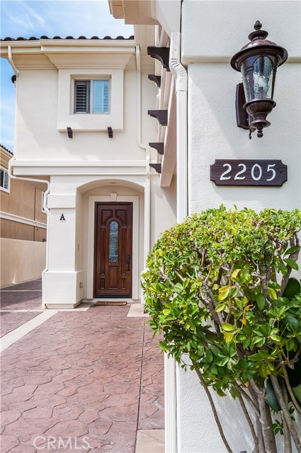 Front walkway with attached 2 car garage just to the right.
