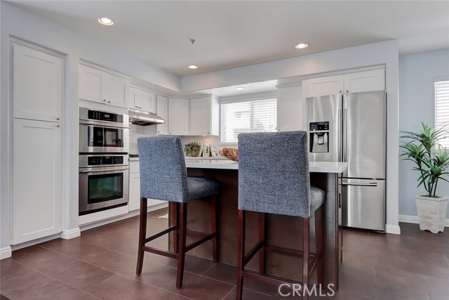 Kitchen island with breakfast bar and additional storage.
