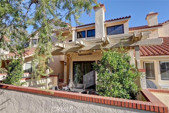 Lush trees and greenery gives this back patio great privacy.