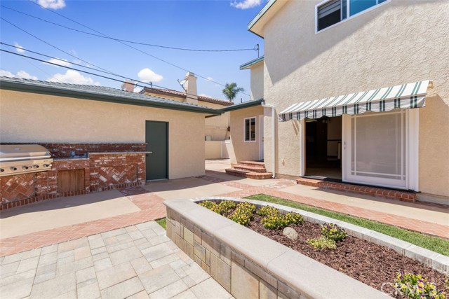 Backyard leads to family room with custom retractable sun shade