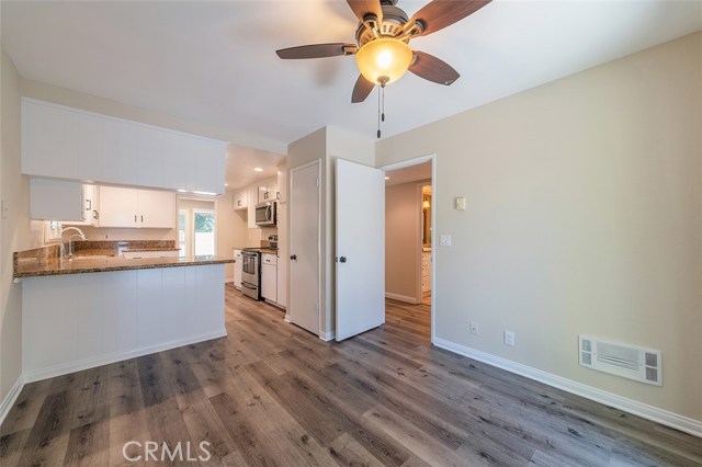 Breakfast nook and breakfast bar looking to kitchen and dining room beyond